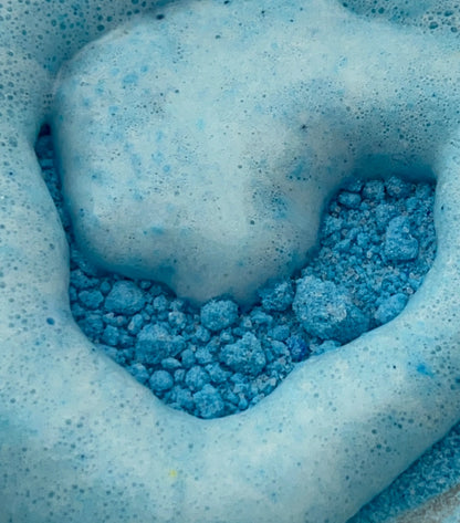 Close-up of blue potion powder making foamy bubbles