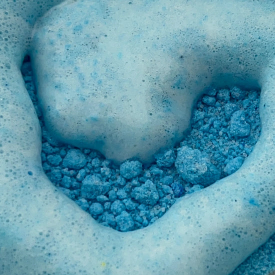 A video of blue potion power with water being poured on. The powder fizzes and bubbles. 